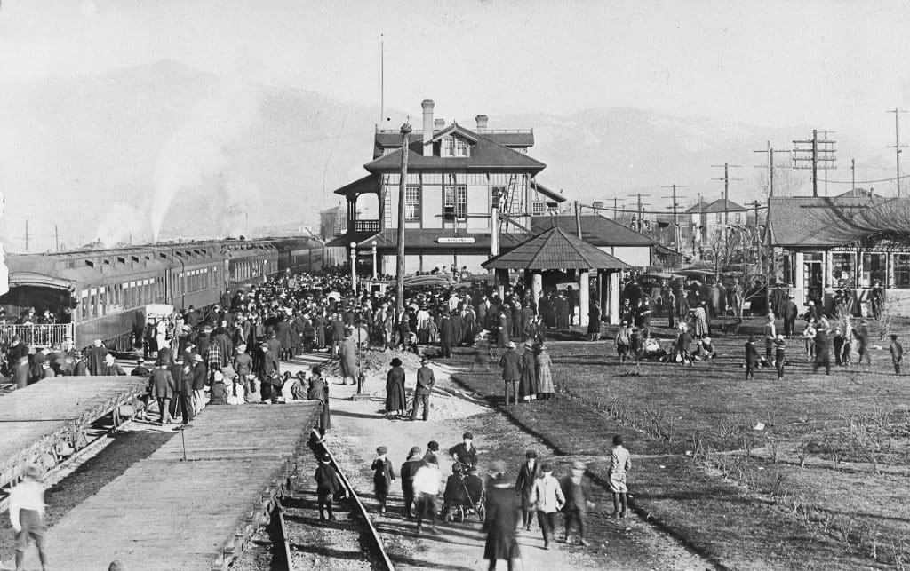 A busy day at the Ashland train station, c1915. Ashland Depot Hotel and Lithia water tasting gazebo are in the photo.