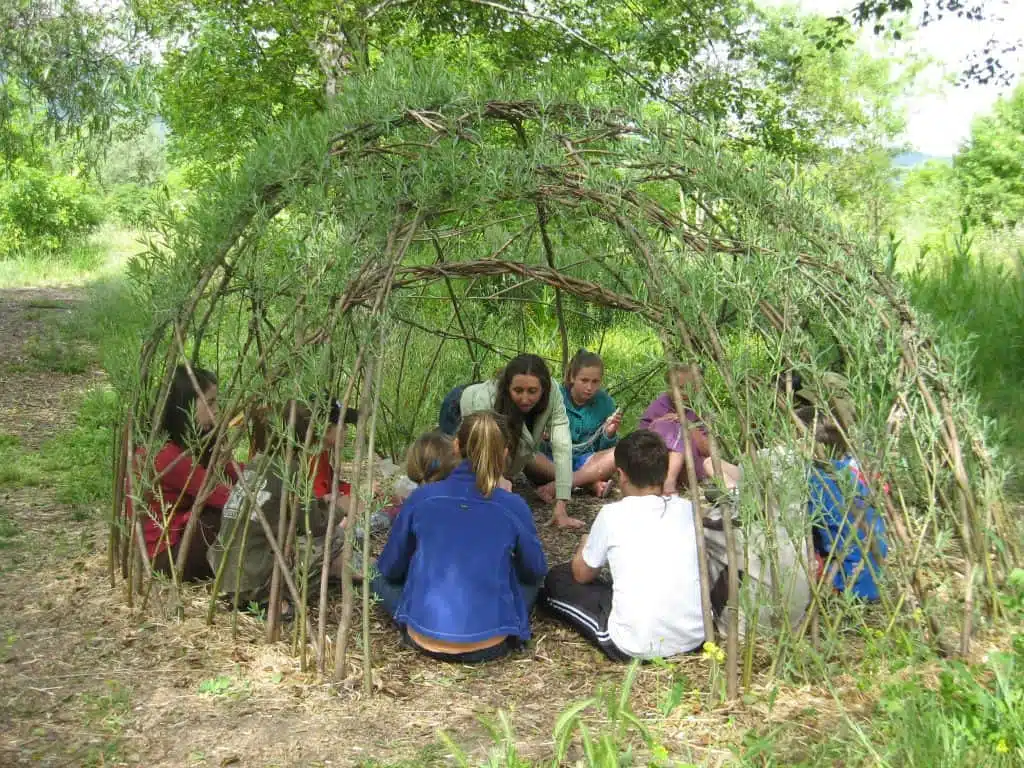 Libby with a kids summer camp in 2011 inside the new Living Willow Hut