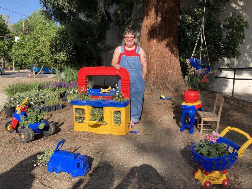 At the opening for Recology Ashland/SOU "artist in residency" program, turning "trash" into art. Photo of artist: Adam Garrett. Title: "To be loved is to be changed."