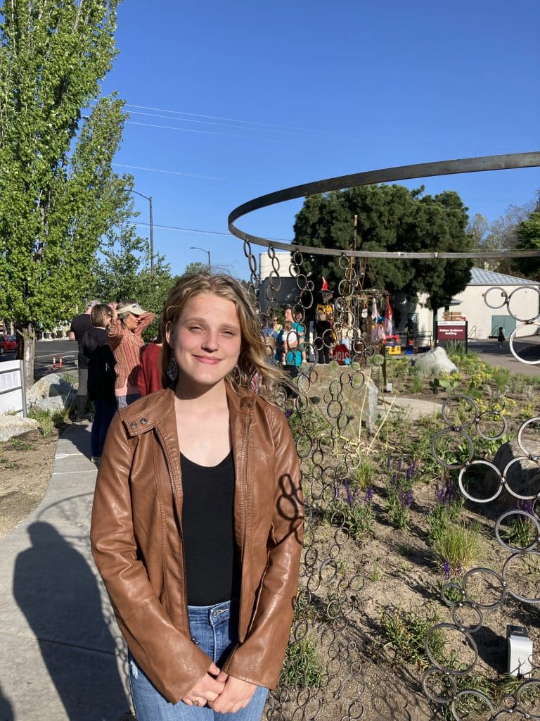 At the opening for Recology Ashland/SOU "artist in residency" program, turning "trash" into art. Photo of artist: Mel Villarreal. Title: Passing Time, Shifting Perspectives.
