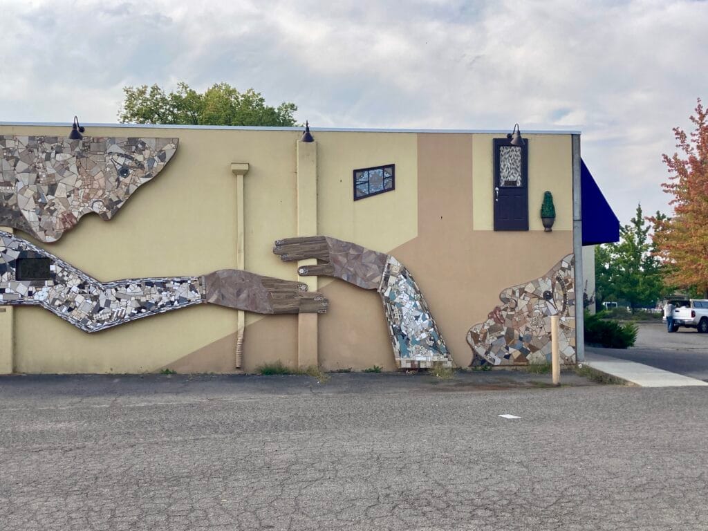 "Uplifting" artwork after Krysta Bannis re-made the hands in 2024.