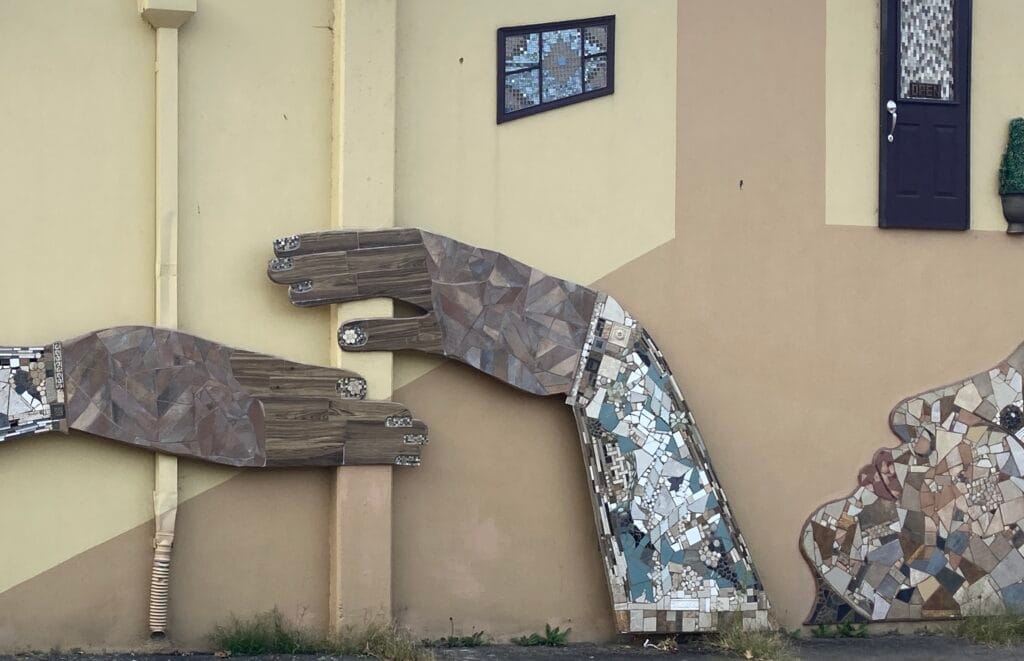 "Uplifting" artwork after Krysta Bannis re-made the hands in 2024, showing a close-up of the hands.