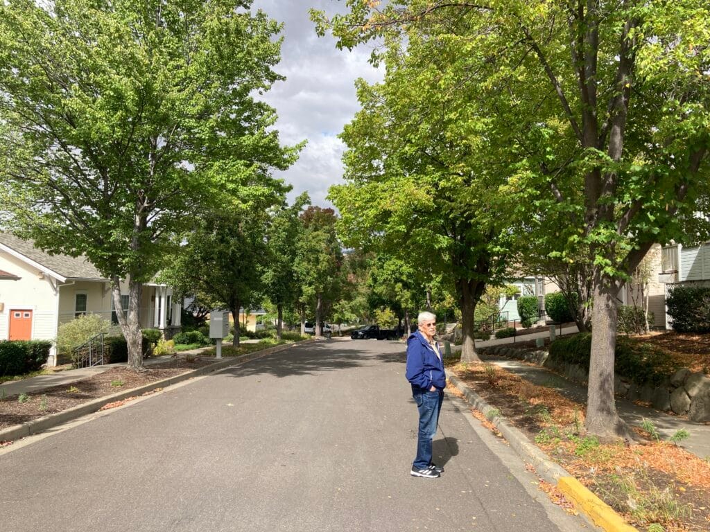 Lee Bowman is showing me River Rock Road, with its 30-year-old trees.