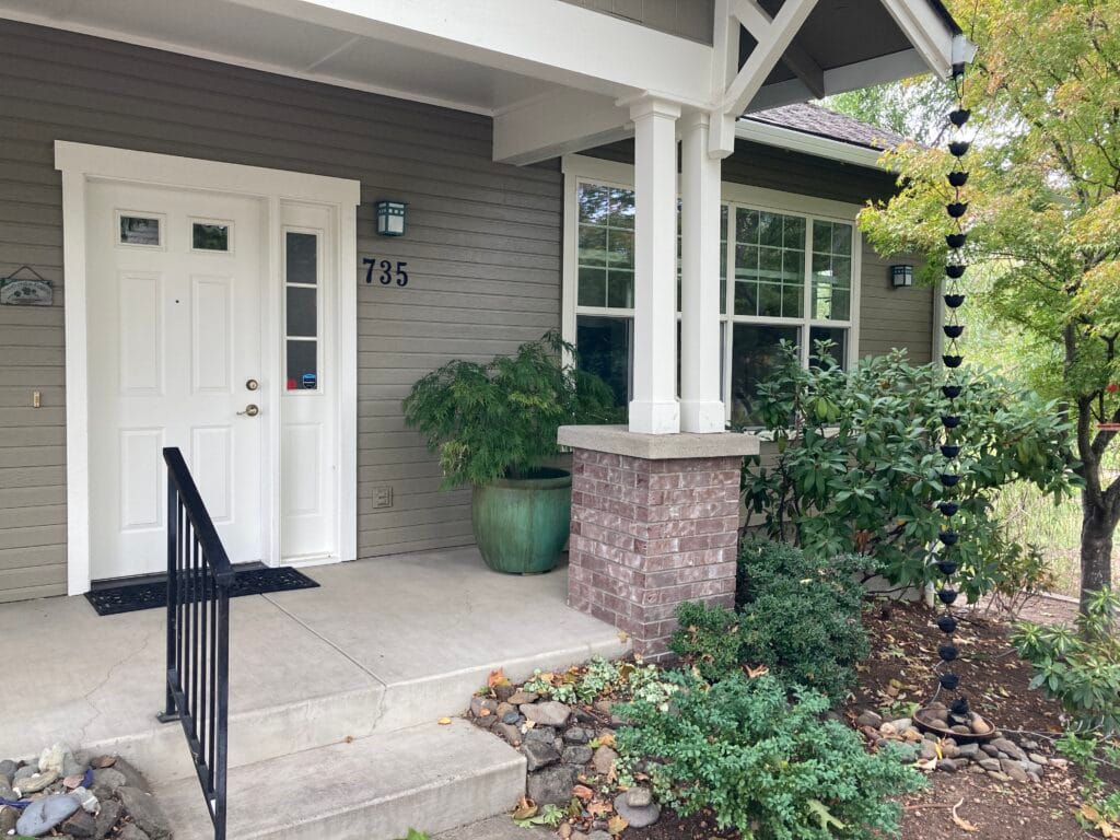 735 Meadowlark Way, with a beautiful garden and steel yard art.