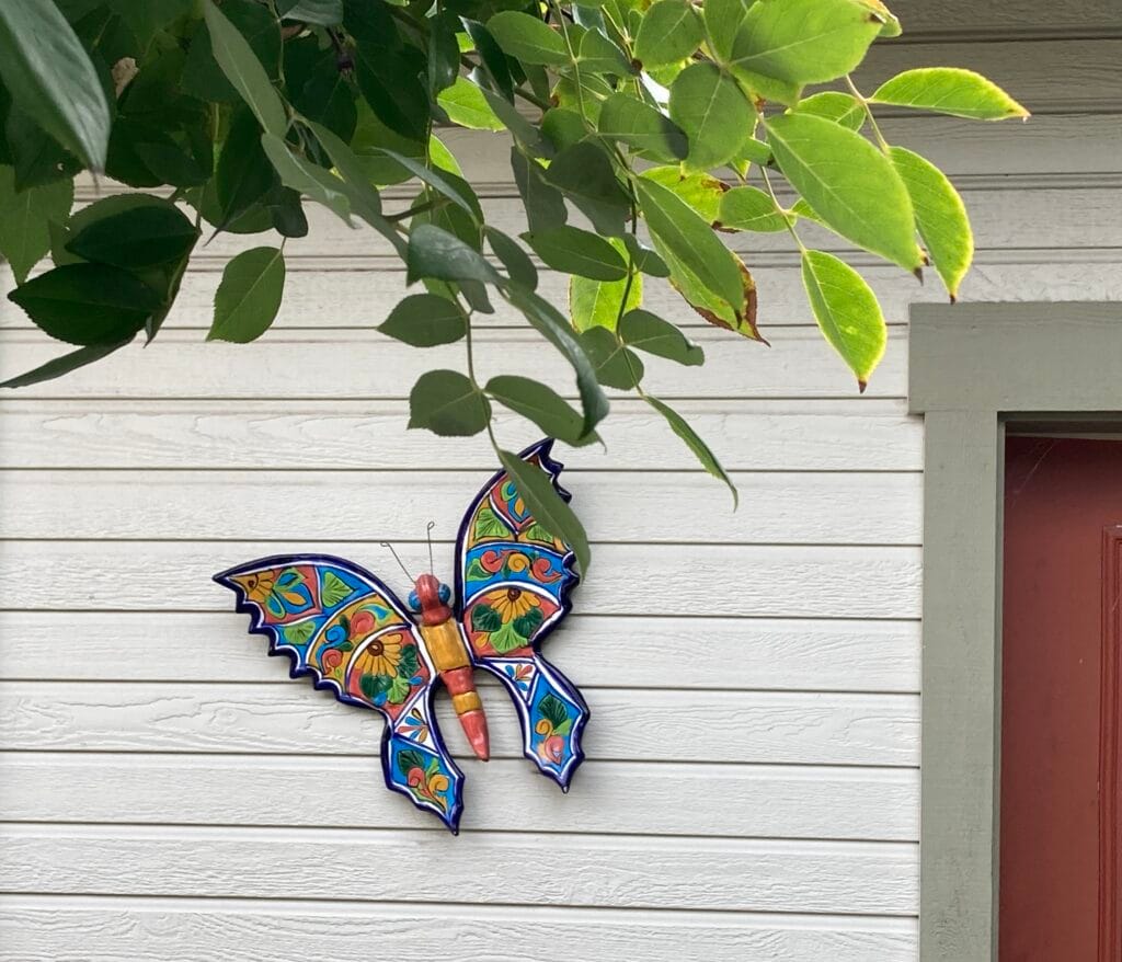 Bold butterfly (pollinator) art on South Alley.