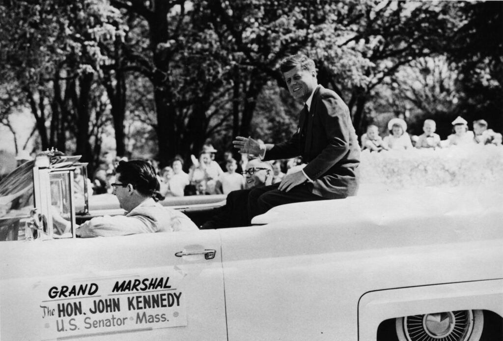 Senator John Kennedy in 1960 Medford Pear Blossom Parade, driven by Wally Watkins. (photo SOHS 07856)