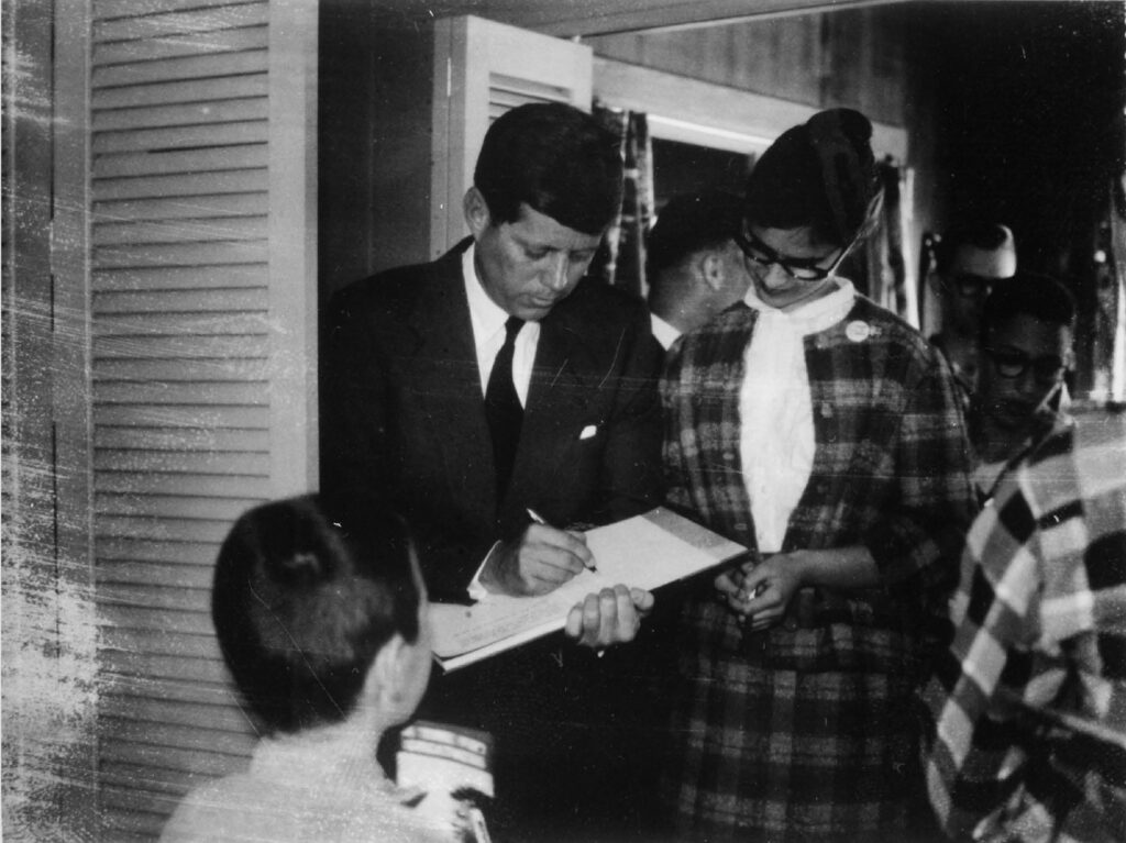 Senator John Kennedy with Karen Fieguth (now Karen Smith), at Kreisman's reception, April 23, 1960. (photo SOHS #88919.1)