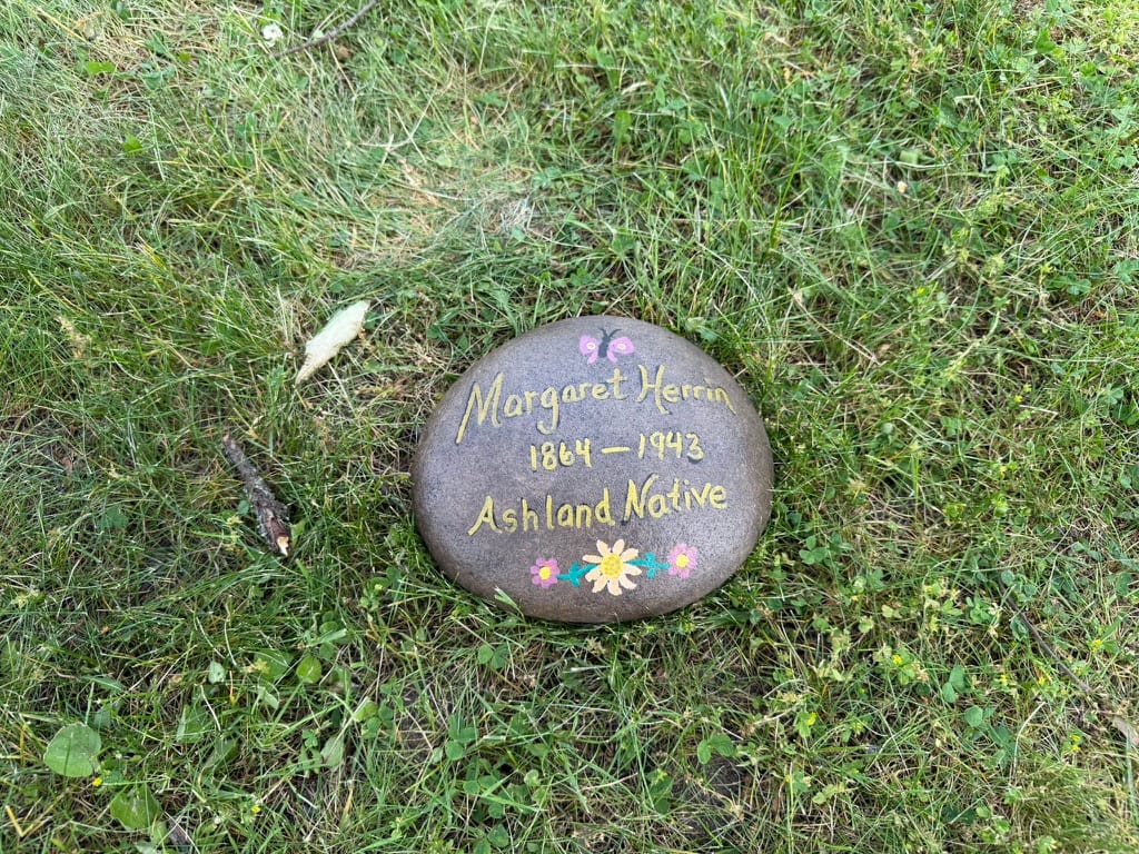 Margaret Herrin is buried here at Ashland Cemetery, but does not have a grave marker. This marker was painted by Judy Singer in May 2026.