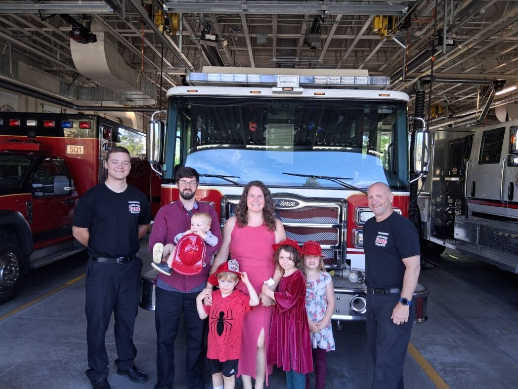Jordan and Glory Nylander, with their four children. At Fire Station No. 1 with Ashland Fire and Rescue staff