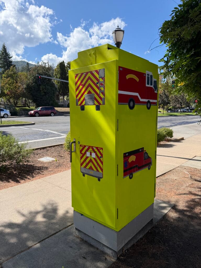 Completed traffic signal box: "Fire Engine and Ambulance." Artist Glory Nylander, with help painting from 9 children and 11 adults