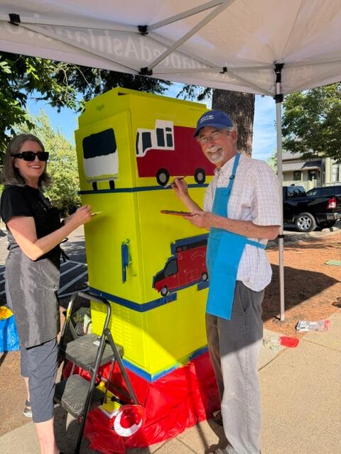 Molly and Peter are painting the traffic signal box: "Fire Engine and Ambulance."